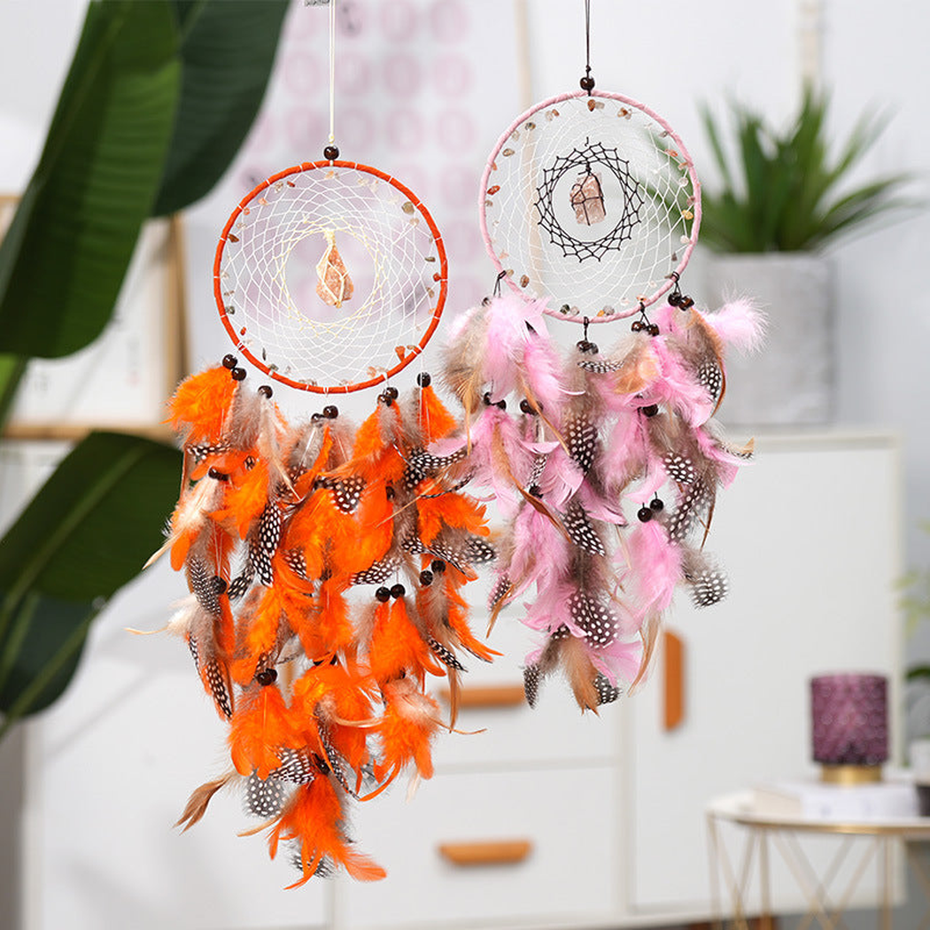 Orange and pink dreamcatchers with circular hoops and hanging feather-look elements