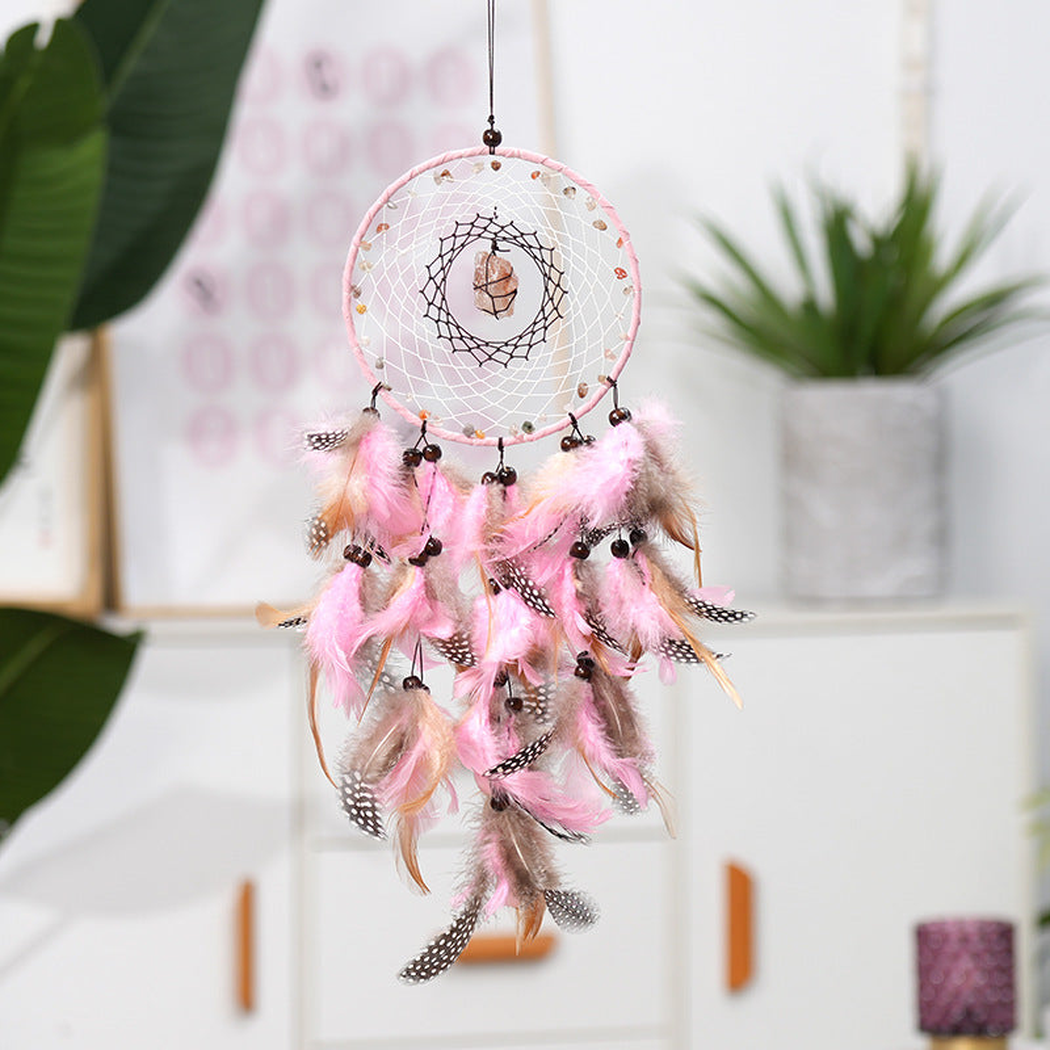 Pink dreamcatcher hanging in a bright interior setting