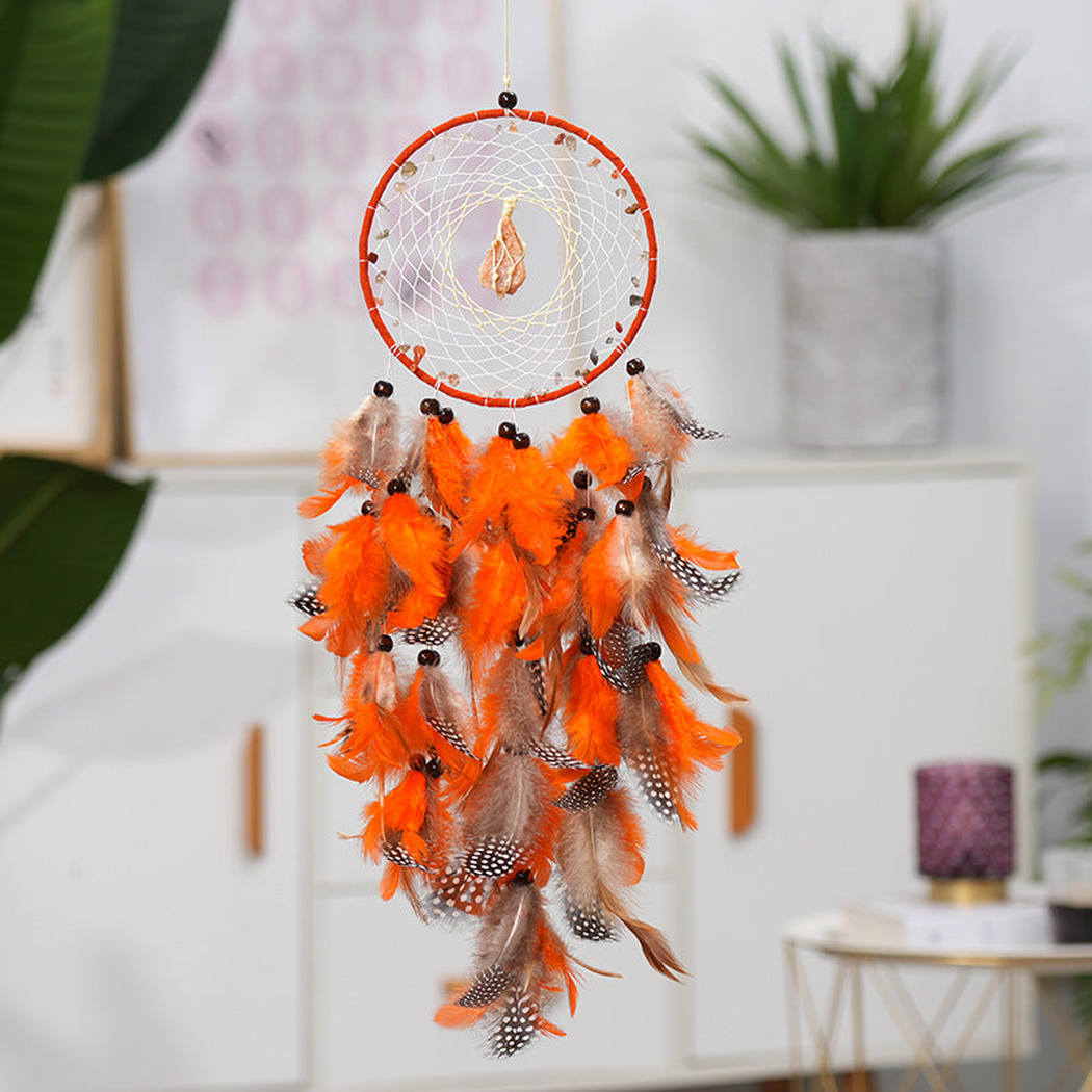 Orange dreamcatcher hanging in a bright interior setting