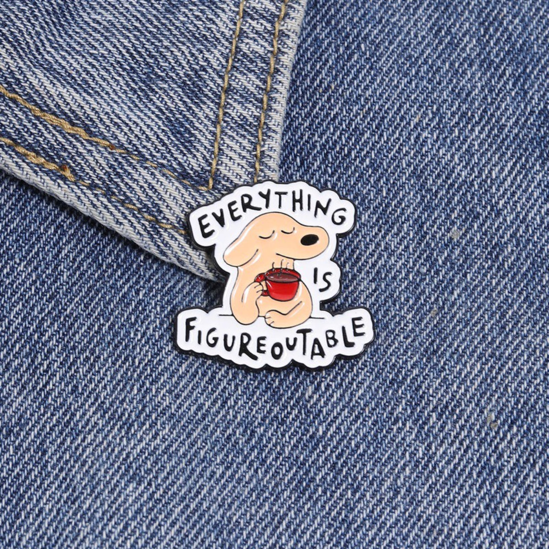 Back side of Pinori Figureoutable dog enamel pin showing metal pin and clasp