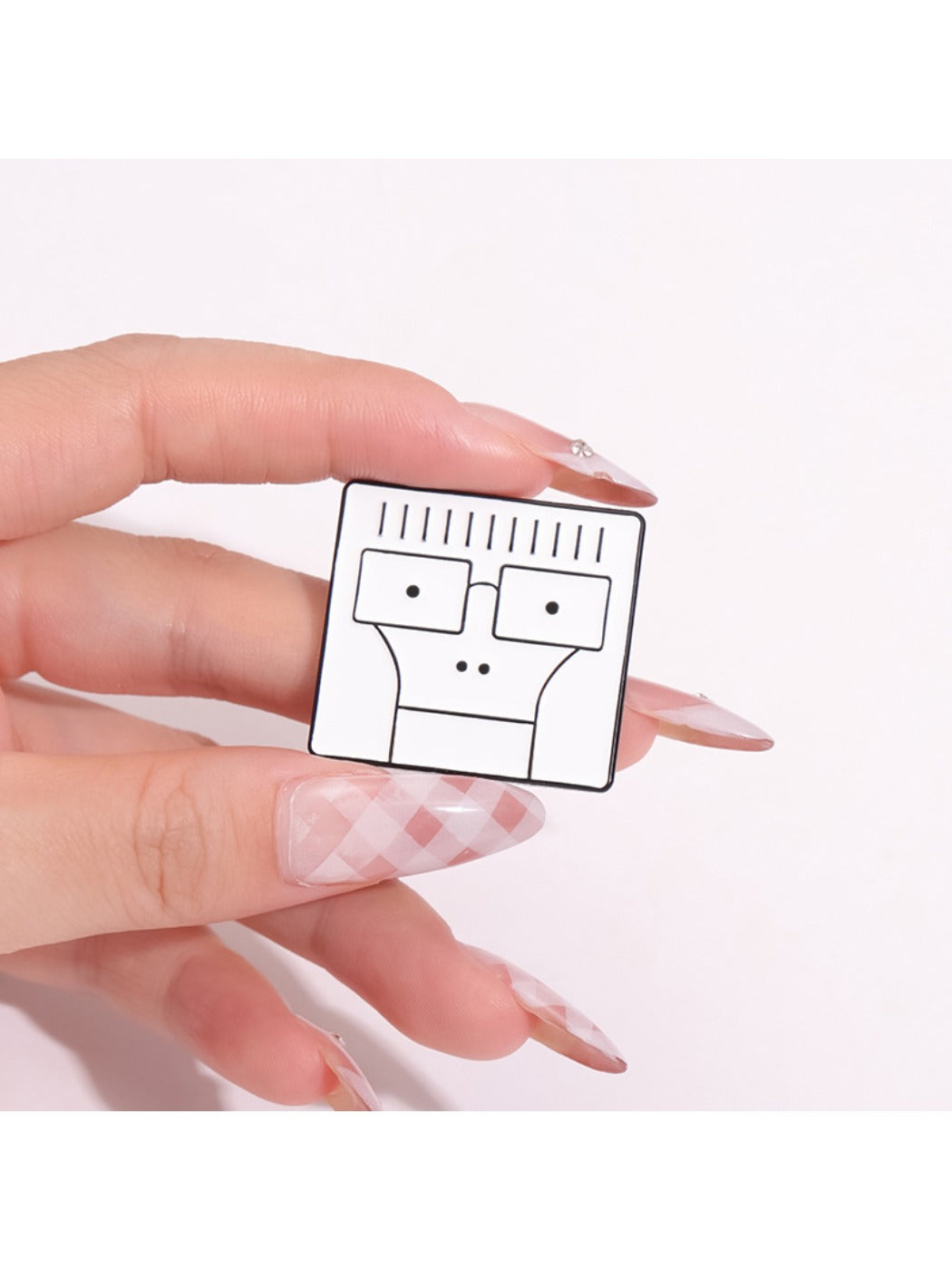 Side view of white cartoon character pin highlighting its thickness and metal backing