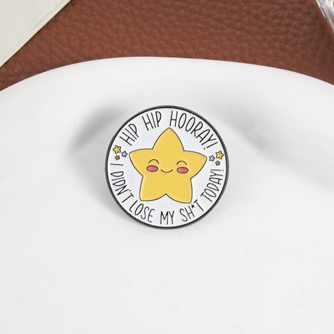 Close-up of Pinori Hip Hip Hooray star enamel pin showing detailed gold edges and enamel colors