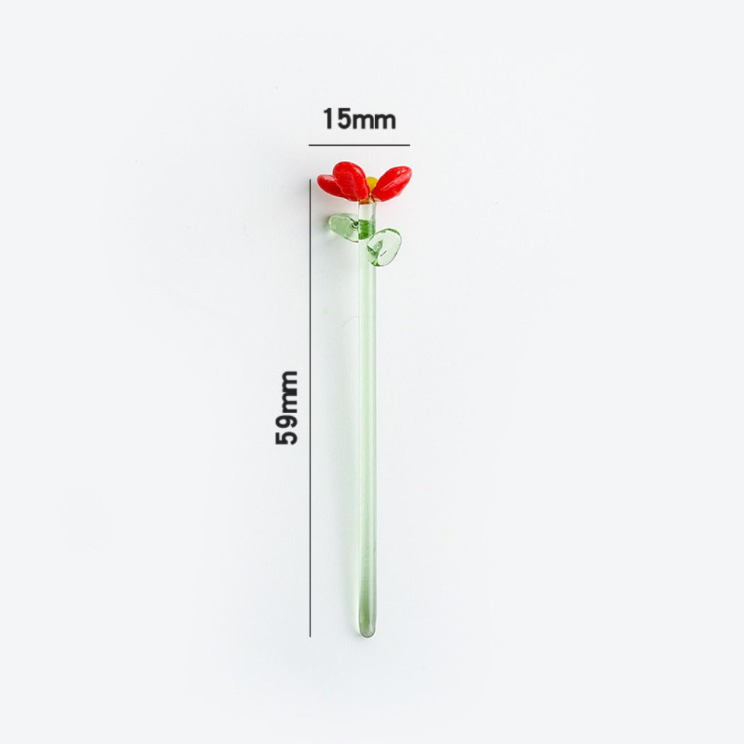 Thimara mini glass daisy resting on a green leaf background