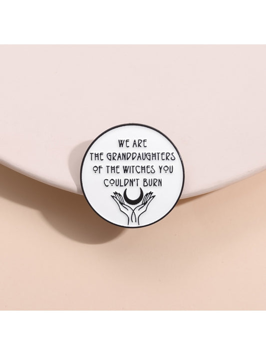 Close-up of Pinori Girl Power Unburnable Badge Pin with pink and gold design