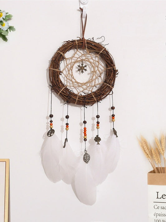 Somnira vintage woven dreamcatcher with intricate web and feathers hanging on wall