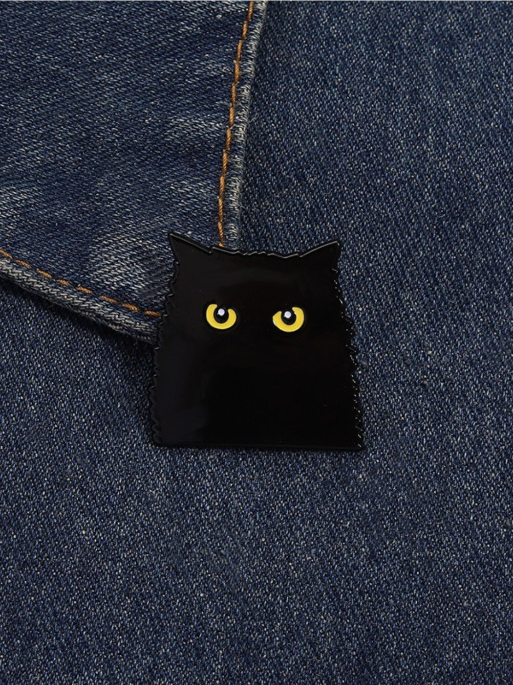 Pinori gothic black cat brooch held in hand for size reference