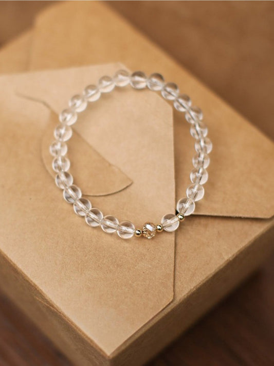 Close-up of Emora white crystal bracelet with silver chain on a white background