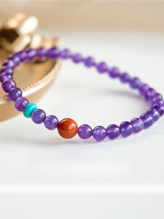 Close-up of Emora lavender amethyst stone bracelet with purple beads on white background