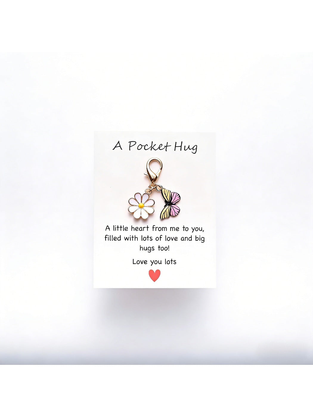 Taphug Pocket Hug Daisy Keychain with white daisy charm and gold ring against dark background