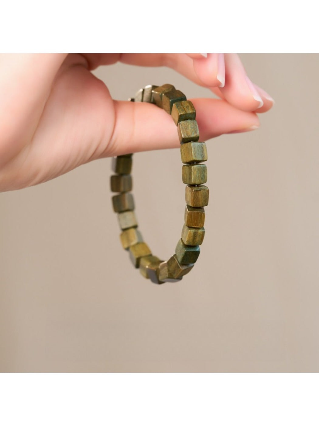 Emora bracelet showing square green beads with elastic band