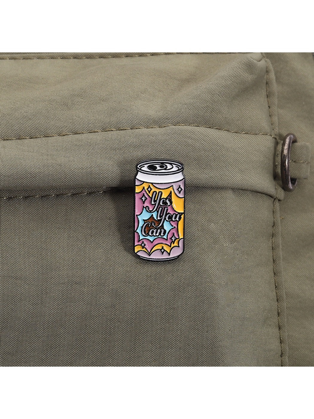 Back view of Pinori punk soda can badge showing metal pin clasp and fastening mechanism