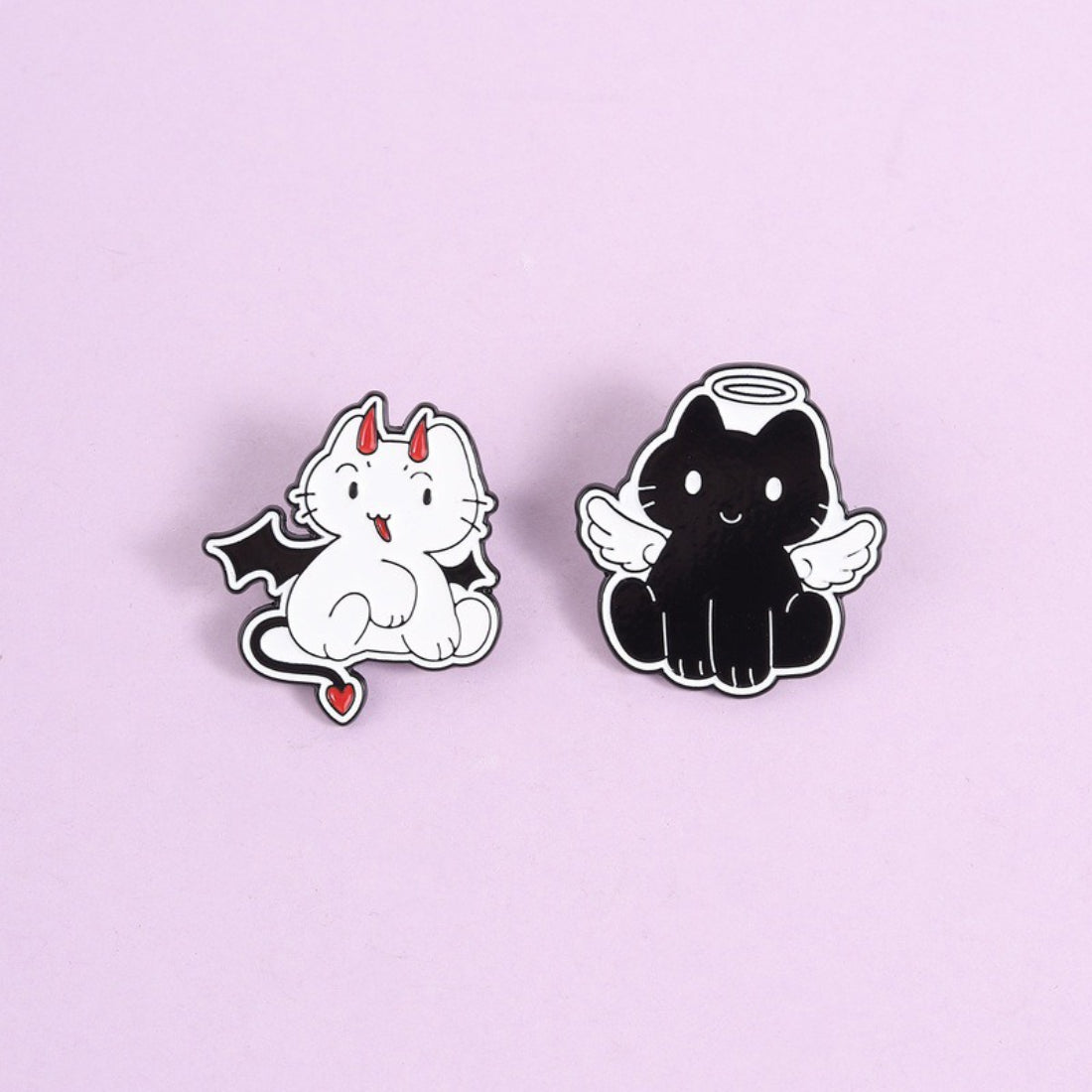 Pinori Angel Devil Cat enamel pin next to a ruler for size reference