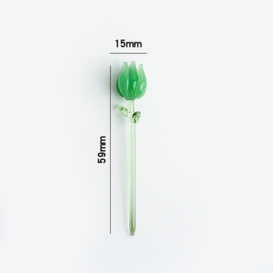 Miniature glass rose with translucent pink petals and a slender green stem on white background