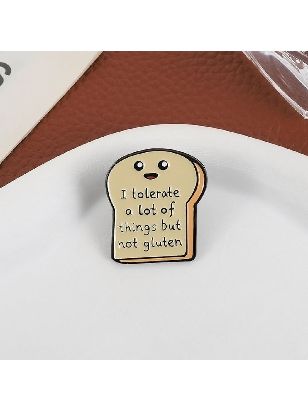 Pinori bread cartoon pin attached to denim fabric