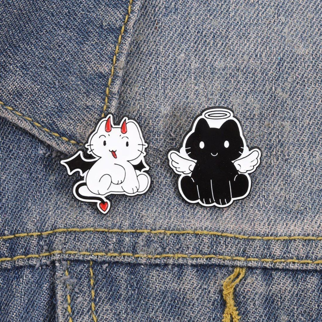 Close-up of Pinori Angel Devil Cat enamel pin highlighting detailed facial features and colors