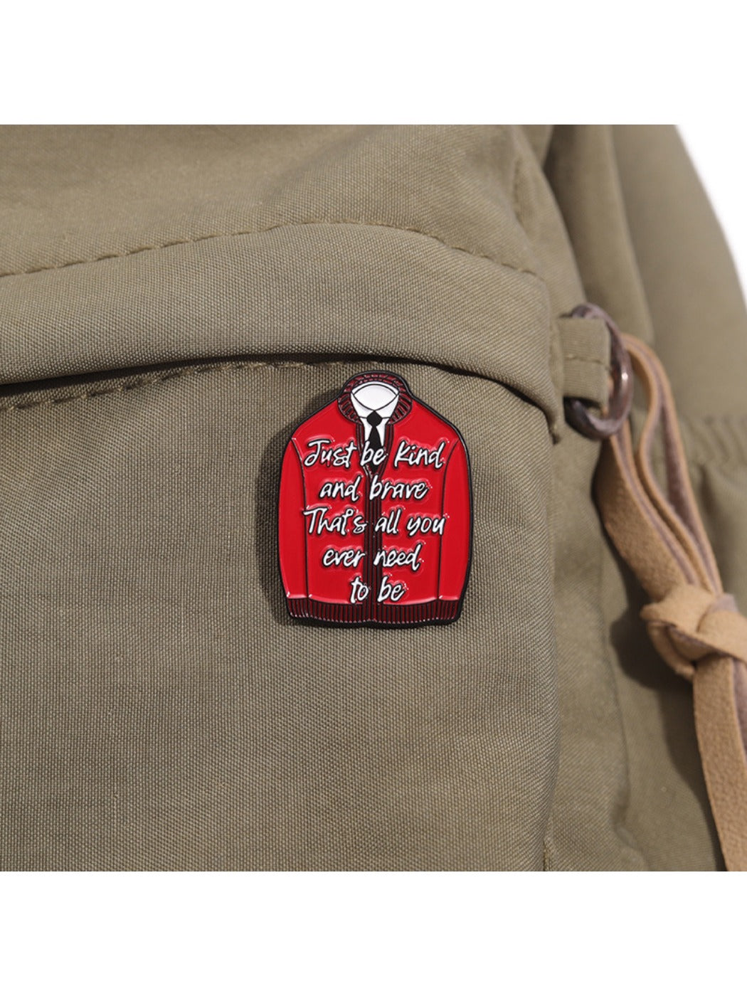 Pinori red badge displayed on black fabric with clear inspirational message