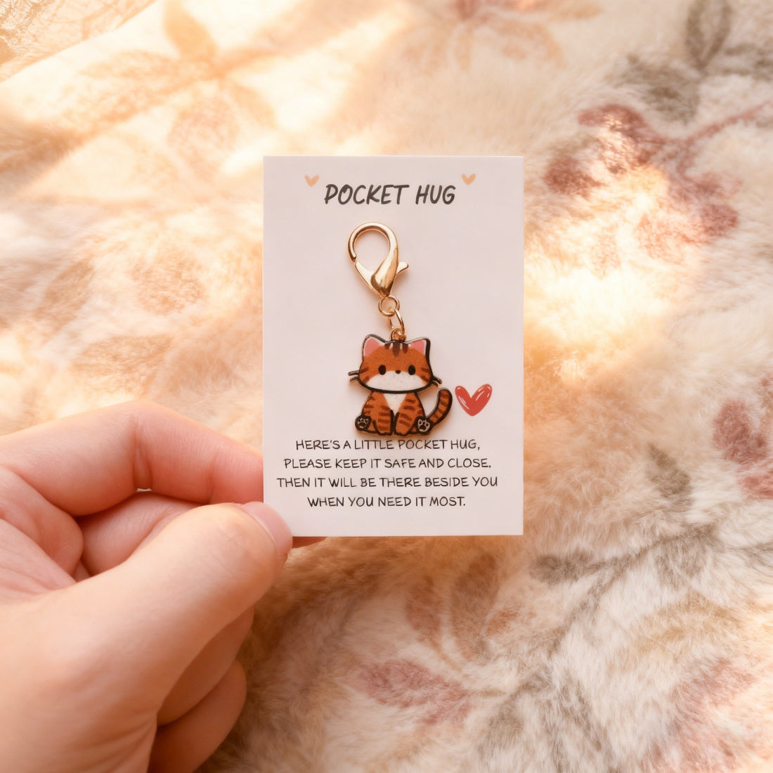 Taphug Kitten Charm Pocket Hug held in hand to show size and portability