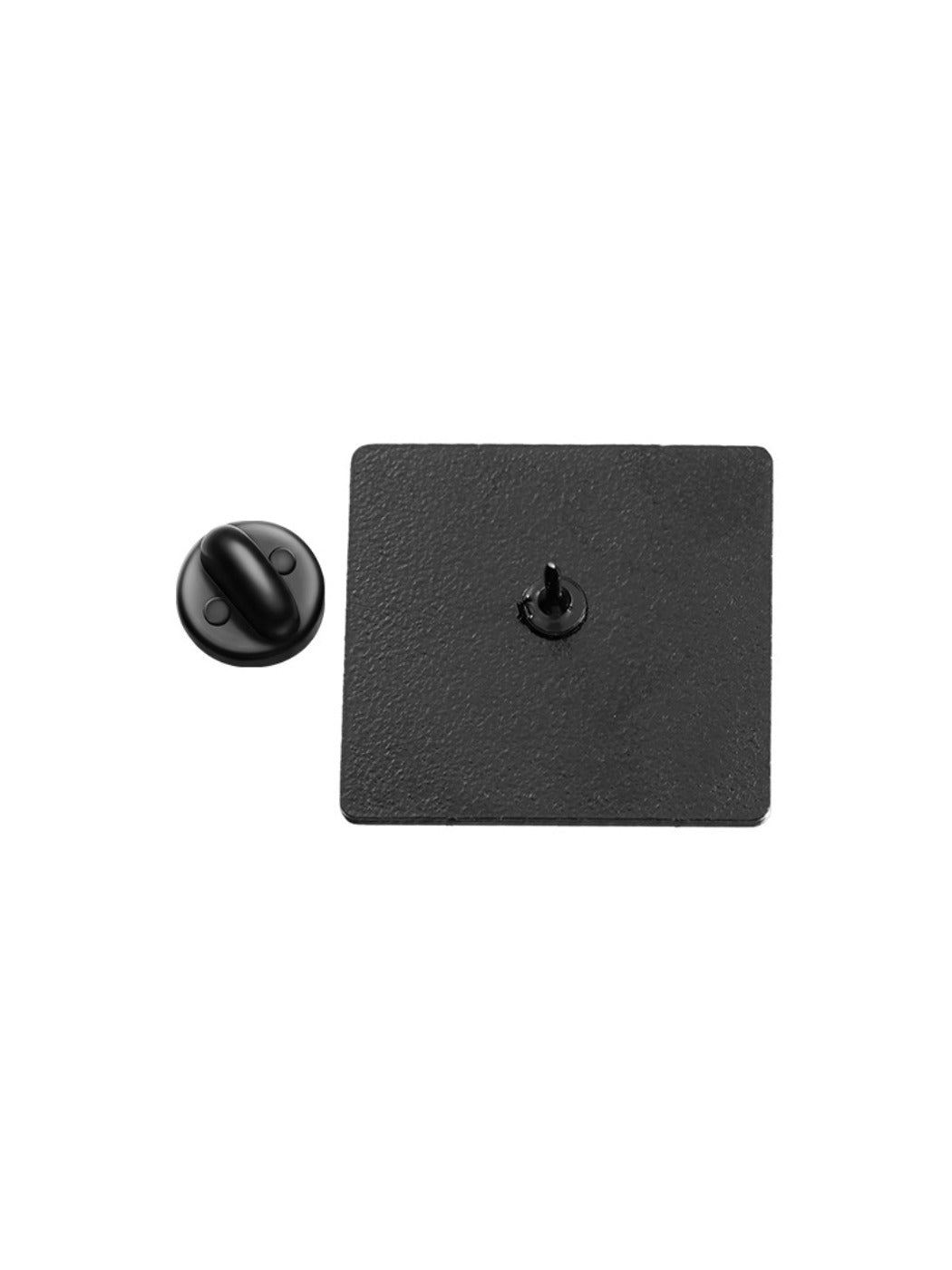 Cartoon character pin displayed on a black fabric surface for contrast